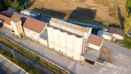Aerial view of feed silos near the driveway and railroad. 