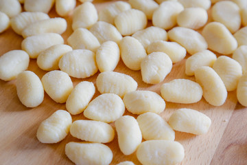 Gnocchi, typical italian pasta, on wooden table, natural light