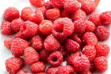 Heap of raspberries on the white background.