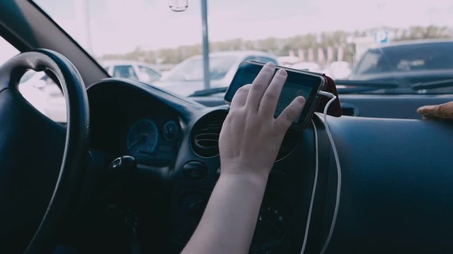 Driver prints destination adress in a car gps navigator