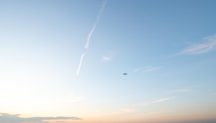 Fototapeta na wymiar Plane over the horizon. Sunset sky. 