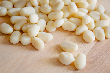 Gnocchi, typical italian pasta, on wooden table, natural light