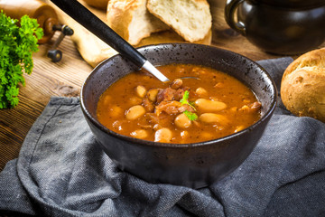 Beans with tomato sauce, bacon and sausage.