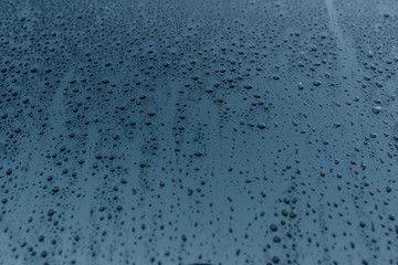 Texture of raindrops on the blue glass.