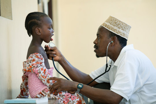 Doctor examining girl in clinic