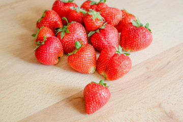 Strawberries on wooden table, natural light