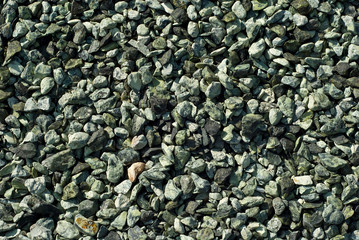 Drainage systems from small pebbles. Garden drainage for plants and trees. Green stones for roads and flower beds.