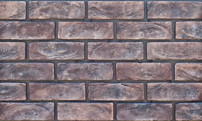 Texture of brick wall. new brickwork. Samples of wall or fence are presented at exhibitions. Violet brick close up.