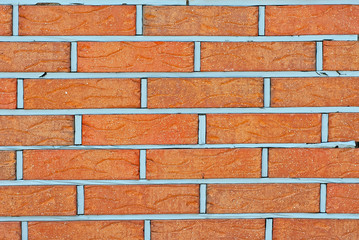 Texture of brick wall. new brickwork. Samples of wall or fence are presented at exhibitions. Orange brick close up.