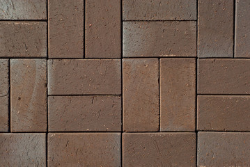 Cobblestone texture. The sidewalk tile is evenly folded. Brown cobblestones close up.