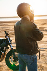 Back view of a young man wearing leather jacket