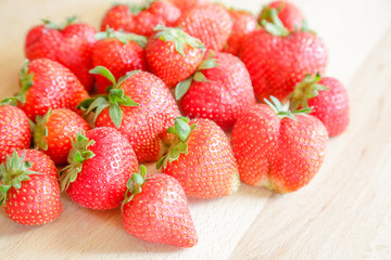 Strawberries on wooden table, natural light