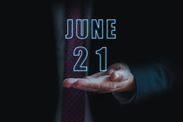 june 21st. Day 20 of month, announcement of date of  business meeting or event. businessman holds the name of the month and day on his hand.. summer month, day of the year concept