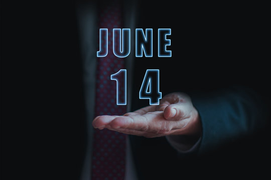 june 14th. Day 14 of month, announcement of date of  business meeting or event. businessman holds the name of the month and day on his hand.. summer month, day of the year concept