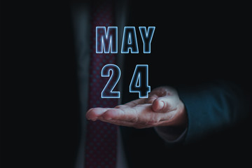 may 24th. Day 24 of month, announcement of date of  business meeting or event. businessman holds the name of the month and day on his hand.. spring month, day of the year concept