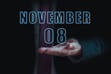 november 8th. Day 8 of month, announcement of date of business meeting or event. businessman holds the name of the month and day on his hand. autumn month, day of the year concept