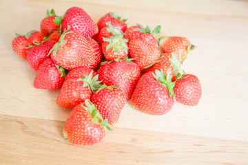 Strawberries on wooden table, natural light