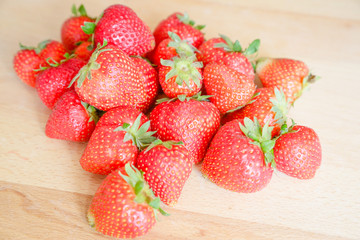 Strawberries on wooden table, natural light