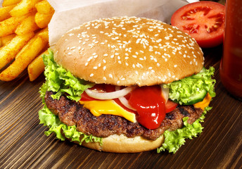 Grilled Cheeseburger with French Fries on wooden Background