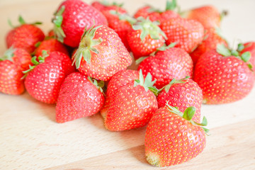 Strawberries on wooden table, natural light