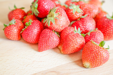 Strawberries on wooden table, natural light