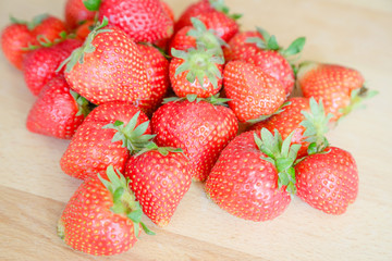 Strawberries on wooden table, natural light