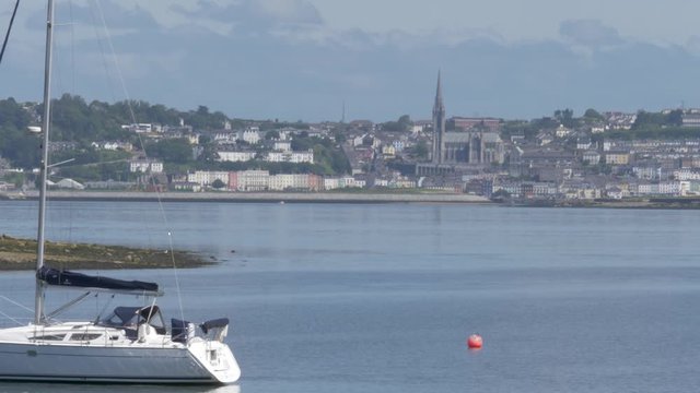 Cobh. The Irish Town Cobh filmed from the opposite coastline. A Yacht is visible in the foreground. Titanics last port.