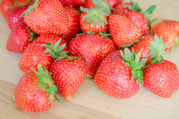 Strawberries on wooden table, natural light
