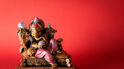 Happy Ganesh Chaturthi festival, Bronze Ganesha statue and Golden texture with flowers, Ganesh is hindu god of Success. - obrazy, fototapety, plakaty