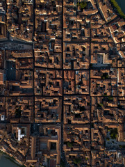 Aerial top down view of narrow streets, houses with tiled orange roofs and squares, old architecture. Florence, Tuscany, Italy.