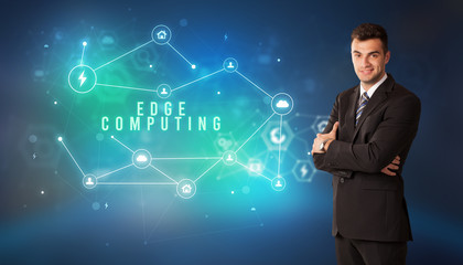 Businessman in front of cloud service icons with EDGE COMPUTING inscription, modern technology concept