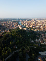 Aerial view of Arno river bend in Florence city, bridges over river, narrow streets, houses with tiled orange roofs, old town squares, italian architecture. Historic centre of Firenze Tuscany Italy