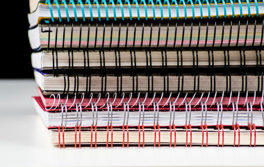 pile of spiral wire notebooks