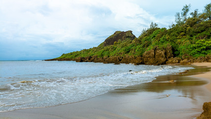 Fototapeta na wymiar Tropical paradise with tall mountain, sea and white sand beach. Nature scene