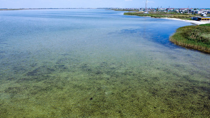 Shore of a clean lake with clear water, bird's eye view