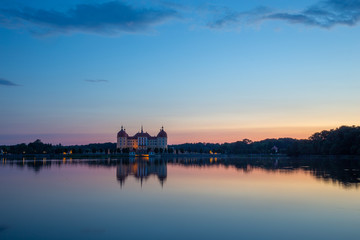 Fototapeta premium Beautiful evening panorama of Moritzburg Baroque palace surrounded by a lake.