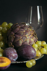 Still life with artichokes, grapes and plums