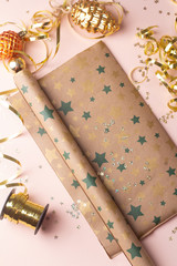 gift christmas wrap and christmas toys on pink background.