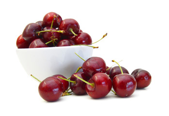 Heart shaped cherry berries and white bowl on white background cutout
