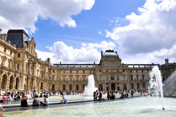 PARIS, FRANCE - JULY 17, 2010: View of pyramid and fountain at courtyard of Louvre Museum. Louvre Museum is one of the largest and most visited museums worldwide.  