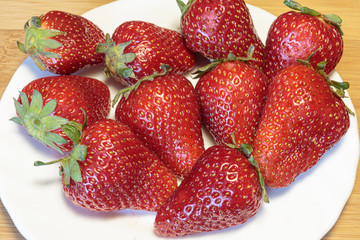 Fresh strawberry from berry farm in the bowl closeup. Concept of a vegan breakfast.
