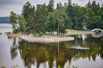 Fototapeta na wymiar Rocks and trees reflected in the lake water