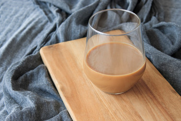 Latte coffee standing on wood, on gray cover, isolated background