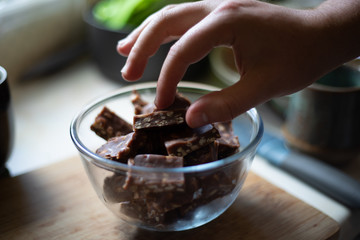 hand picking up chocolate
