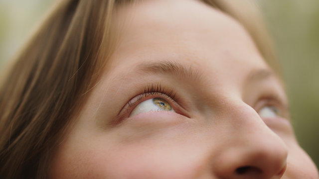 Happy Young Caucasian Girl, Natural Beauty, Smiling In Nature. Extreme Close Up On Her Green Eyes. High Quality Photo