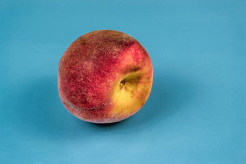 Large ripe juicy peach. Blue