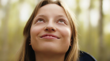 Fototapeta premium Natural beauty. Young woman with green eyes and toothy smile with no make up in the nature. High quality photo