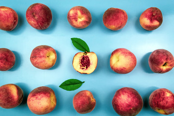 Background of ripe juicy peaches on blue