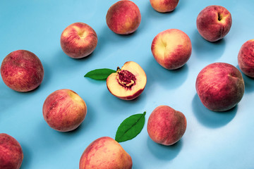 Background of ripe juicy peaches on blue