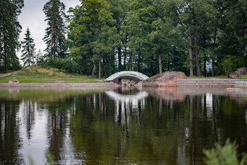 White bridge on the lake shore reflected in the water